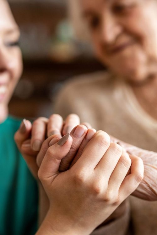 Cropped shot of a senior woman holding hands with a nurse Cropped shot of a senior woman holding hands with a nurse