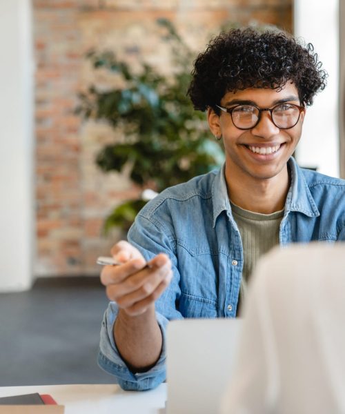 Successful young colleagues having negotiation at the working desk in office Successful young colleagues having negotiation at the working desk in office