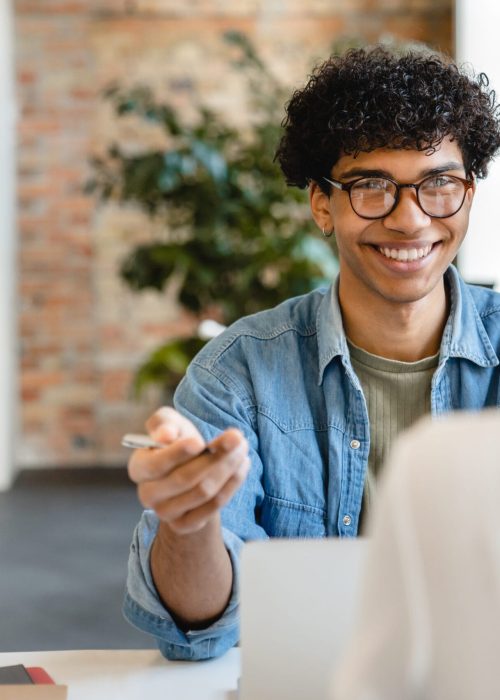 Successful young colleagues having negotiation at the working desk in office Successful young colleagues having negotiation at the working desk in office